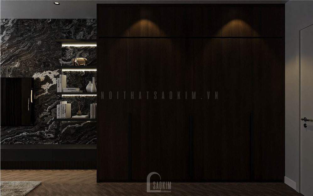 Tủ quần áo được thiết kế bằng gỗ tối màu đặt bên cạnh vách treo tivi